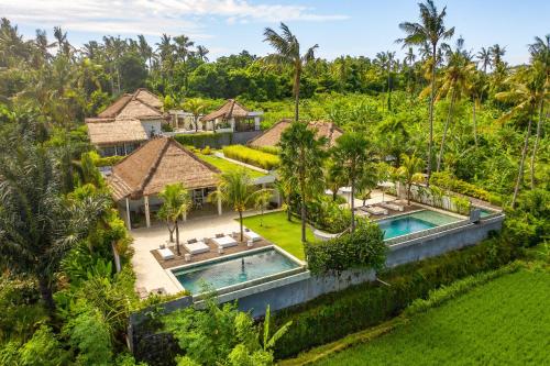 an aerial view of a villa with two swimming pools at Balidroomvilla's in Karangasem