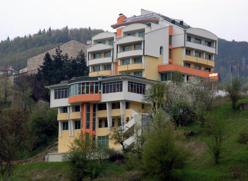 a large building on top of a hill at Хотел Дикас in Smolyan
