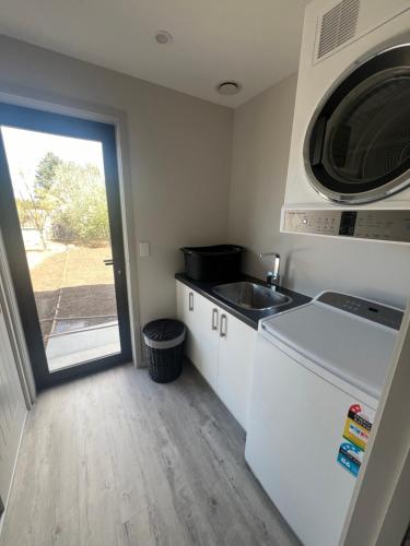 a small kitchen with a sink and a microwave at Southern Comfort in Kurow