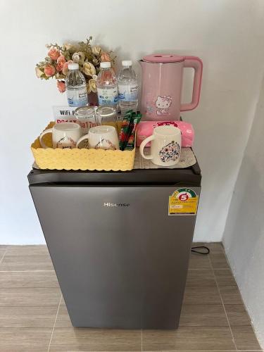 a table with a tea set on top of a refrigerator at Peang Tara Cafe & Resort in Nong Khai
