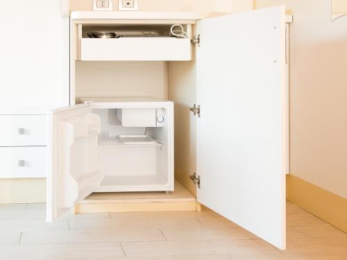 an open refrigerator with its door open in a kitchen at Arco delle Rose Rooms in Agropoli