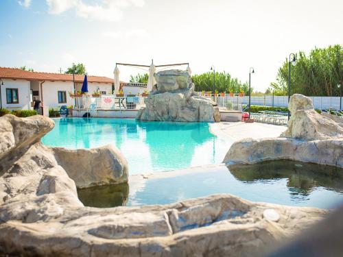 a swimming pool with a water slide in a resort at Arco delle Rose Rooms in Agropoli