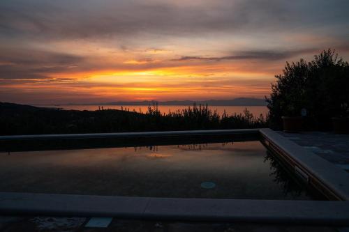 a view of a sunset from a swimming pool at Villa Roza in Splitska