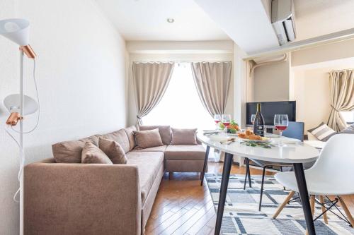 a living room with a couch and a table at Racine難波 in Osaka