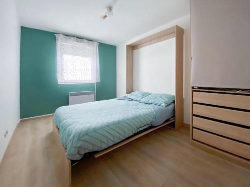 um pequeno quarto com uma cama e uma janela em Le Saint Pierre - T2 refait em Saint-Pierre-de-Chandieu