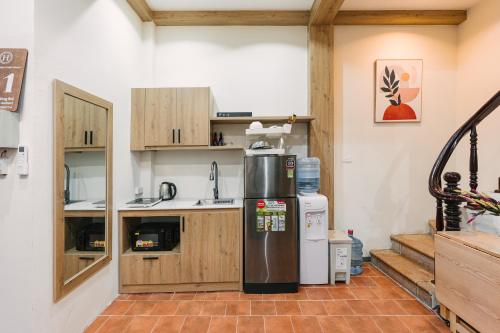 a kitchen with a refrigerator in the middle of a room at Hi-Home HanoiCenter Big Group-4BRs 2mins to HoanKiem Lake in Hanoi