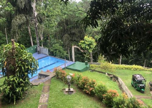 a car parked next to a swimming pool in a yard at Green Hill Paradise Villa in Unawatuna