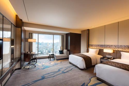 a hotel room with two beds and a view at DoubleTree by Hilton Hotel Anshun in Anshun