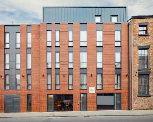 an exterior view of a brick building at Tunnage Square Apartments Duke St by EPIC in Liverpool