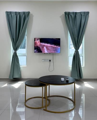 a coffee table in a room with two windows at 13A Homestay 14D in Port Dickson