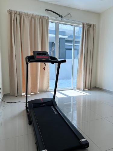 a treadmill in a room with a large window at 13A Homestay 14D in Port Dickson
