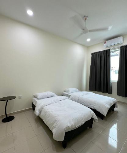 two beds in a room with a window at 13A Homestay 14D in Port Dickson
