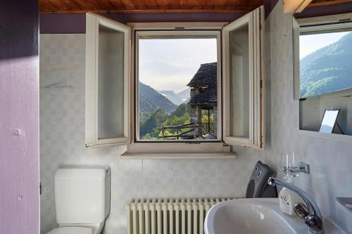 a bathroom with a sink and a window at Wild Valley Puro Ticino 1+2 in Valle Onsernone in Crana