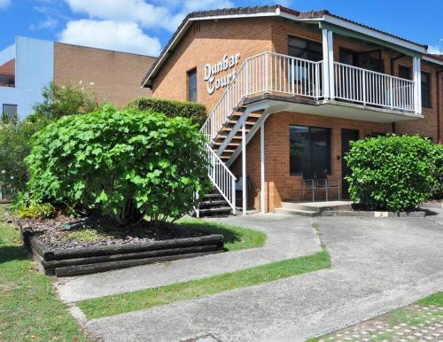 a brick building with a staircase in front of it at Waters Edge - Dunbar Court - Central Location in South West Rocks