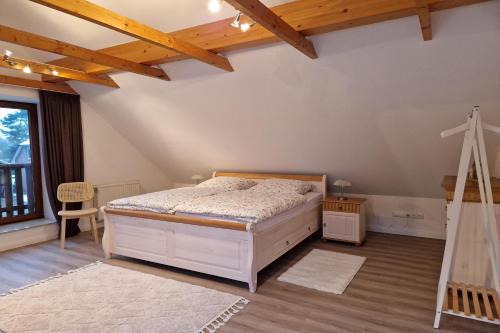 a bedroom with a bed and a cross on the wall at Ferienhaus LandMeer in Gödenstorf