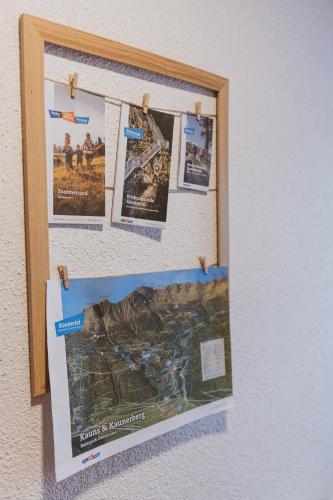 a bulletin board with posters on a wall at Gästehaus Annemarie in Kauns