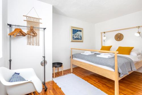 a bedroom with a bed and a chair at Vila Marak in Risika