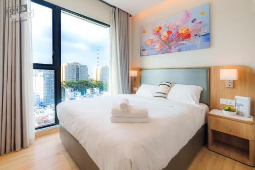 a bedroom with a large bed with a large window at Son&Henry Zenity District 1 in Ho Chi Minh City