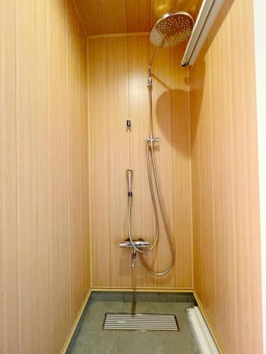a shower with a shower head in a bathroom at Niseko White Villas YUNOSATO in Rankoshi