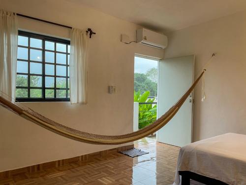 a hammock in a room with a window at Casa Sacek in Valladolid