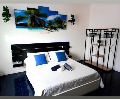 a bedroom with a large bed with blue pillows at VILLA LEA in Torre dell'Orso