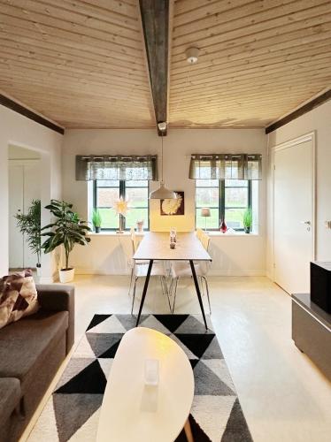 a living room with a table and a couch at Kåseberga Byhus in Ystad