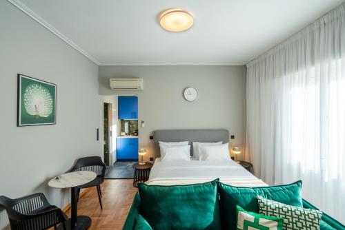 a bedroom with a bed and a couch at Syntagma Bliss: Athens Hub in Athens