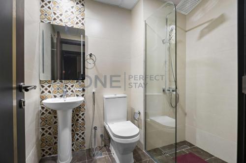 a bathroom with a toilet sink and a shower at 2BHK Gem at Jewelz by Danube in Dubai