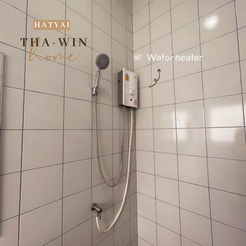 a shower in a bathroom with words on the wall at This house is not open right now Tha-win Home-City Charm Adventure with stylish Hat Yai retreat in Hat Yai