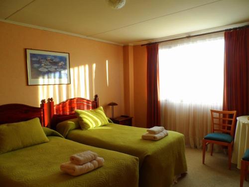 a bedroom with two beds with teddy bears on them at Lady Florence Dixie in Puerto Natales