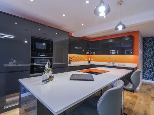 a kitchen with an island with a laptop on it at Magnolia House in Reading