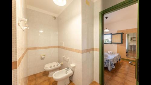 a bathroom with a toilet and a sink at Quaint Residence I Mirti Bianchi n6978 in Santa Teresa Gallura