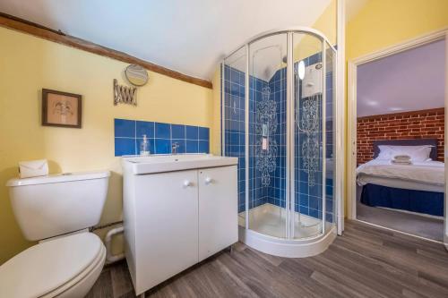 a bathroom with a toilet and a shower at The Old Barn in Semer