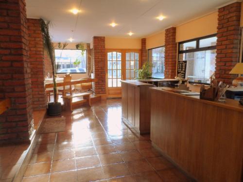 a kitchen with a counter and a dining room at Lady Florence Dixie in Puerto Natales