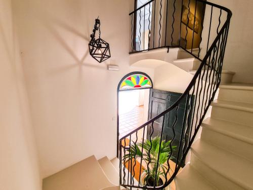 a staircase with a stained glass window in a house at Agroturismo Santa Mariana in Alaior