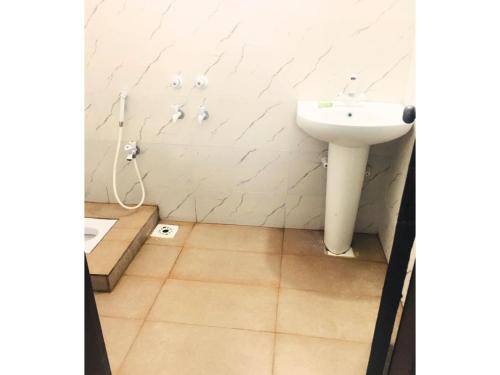 a bathroom with a sink and a toilet at Second Home Guest House Near Agha, Khan Airport in Karachi