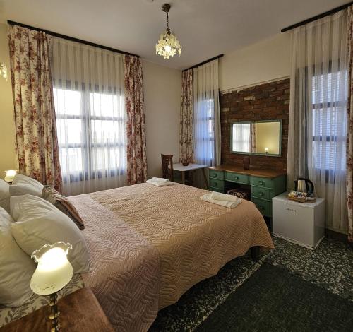a bedroom with a large bed and a mirror at Origin Rooms Urla in Urla