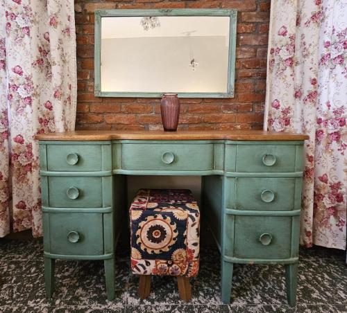 a green dresser with a mirror on top of it at Origin Rooms Urla in Urla