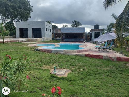 a backyard with a swimming pool and a house at Immaculate 5-Bedroom Villa Garden in Dar es Salaam in Dar es Salaam