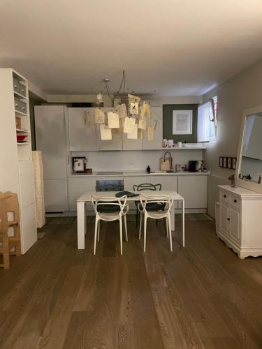 a kitchen with a table and chairs in a room at Casa Clima di fronte al parco in Bologna