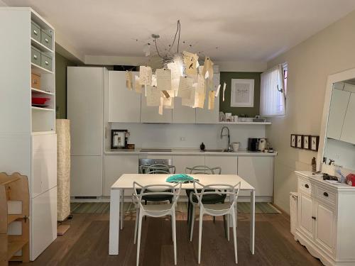 a kitchen with a table and chairs in it at Casa Clima di fronte al parco in Bologna