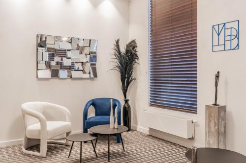 a living room with two chairs and a table at Maison Bruges in Bruges