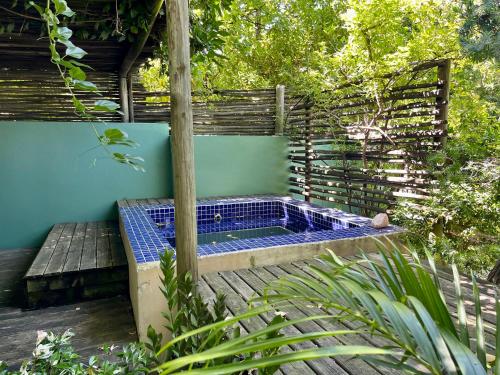 a hot tub sitting on a wooden deck at Serene Garden Flat in Ceres