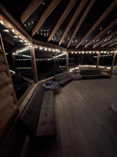 an inside view of a room with a couch and lights at Bârlogul Vikingilor in Şotrile