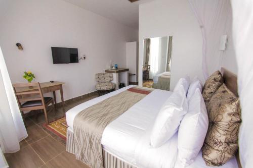 Una cama o camas en una habitación de Lukenya Getaway