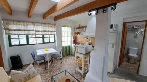a kitchen with a table and a sink and a stove at Beautiful 1-Bed House 'Oficina' Finca Vistamar in Salobre
