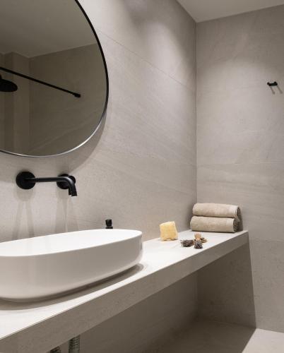 a bathroom with a sink and a mirror on the wall at Philoxenia Hotel in Psakoudia