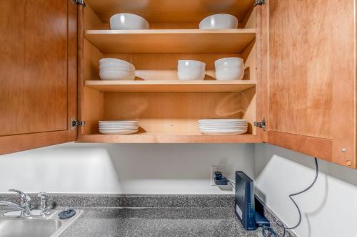 a kitchen with a sink and a cabinet with dishes at Central Square 2br w fitness close to dining BOS-993 in Cambridge