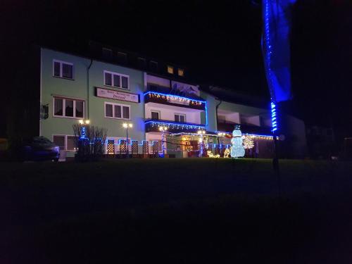 a building with lights in front of it at night at Gruppenferienhaus Dressel in Warmensteinach