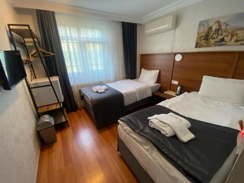 Säng eller sängar i ett rum på Timex Suites